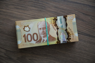 Canadian currency and flag, household budget planning, Canadian economy