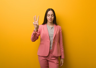 Young modern business woman showing number three