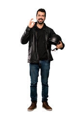 Fototapeta premium Full-length shot of Biker man showing ok sign with fingers over isolated white background