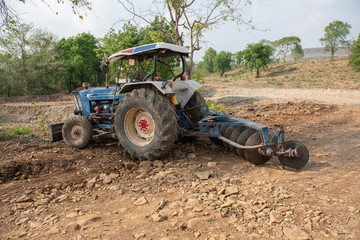 Parking tractor for agricultural machinery, seeding and sowing crops at field.