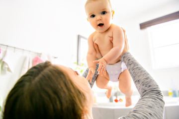 A mother and baby in a bath having fun