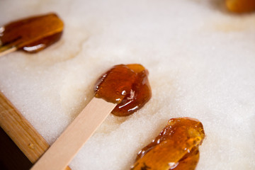 Making maple candy on snow in a maple sugar camp in New Brunswick