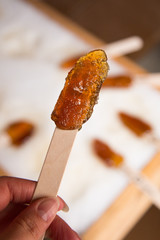 Making maple candy on snow in a maple sugar camp in New Brunswick