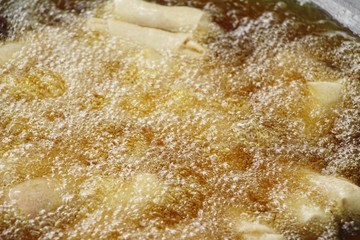 fried spring rolls in pan at street food