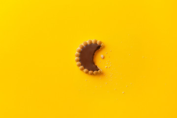 Sweet biscuit with chocolate filling isolated on a yellow background. Top view