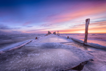 Winter seascape of wood breakwaters on frozen Baltic sea