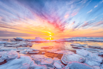 Fantastic view of the sea landscape with ice floe. Sunset at the Baltic sea