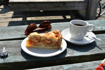 Cup of coffee and apple cake on wooden table