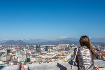 Fototapeta na wymiar Woman admiring the view of city of Ljubljana