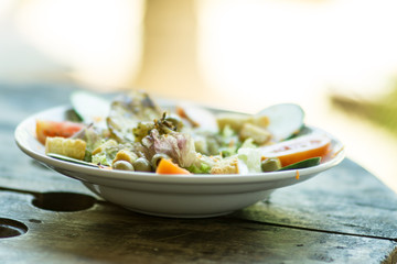 fish salad served in a deep plate, selective focus photography