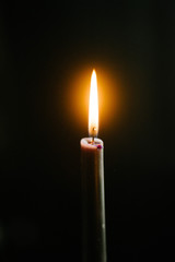 Burning candle on a dark background