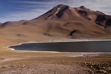 View on deep blue lake at Altiplanic Laguna (Lagoon) Miscanti in Atacama desert with partly snow capped cone of volcano Meniques in the background - Chile © Ralf