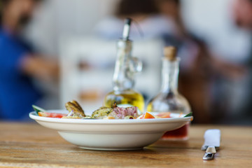 fish salad served in a deep plate, selective focus photography