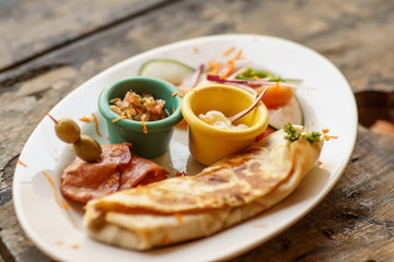 Burrito served on plate as breakfast. Typical Mexican food, selective focus photography
