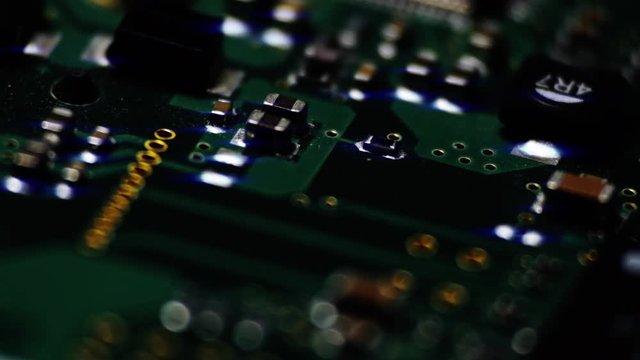 Circuit Board / Processor Chips / Micro Electronics. Macro tracking shot over green circuit board.