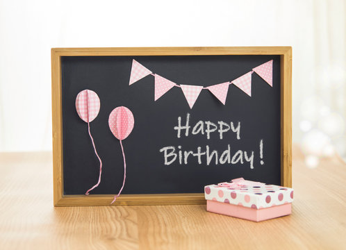 Happy Birthday blackboard. Cute background with pink decoration.