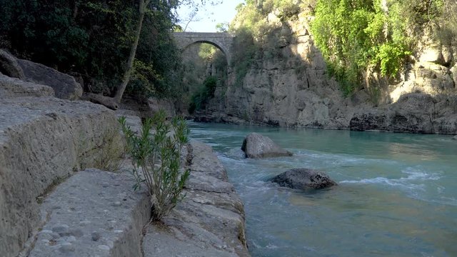 Antalya, Turkey - March 2019: Antique Oluk Bridge across Kopru Irmagi creek in Koprulu Kanyon national park in Antalya Turkey.