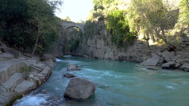 Antalya, Turkey - March 2019: Antique Oluk Bridge across Kopru Irmagi creek in Koprulu Kanyon national park in Antalya Turkey.
