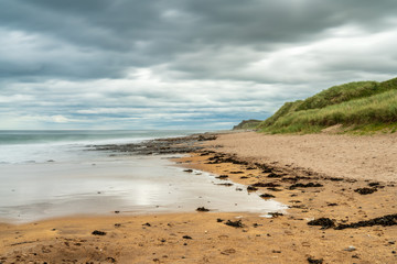 Dramatic sky over a beach, seen at Cocklawburn Beach near Berwick-upon-Tweed in Northumberland, England, UK