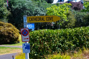 Selbstklebende Fototapeten Dom Bucht Yellow Cathedral Cove sign  © Klanarong Chitmung