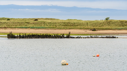 Old Shipwreck on the shore of the River Coquet in Amble, Northumberland, England, UK