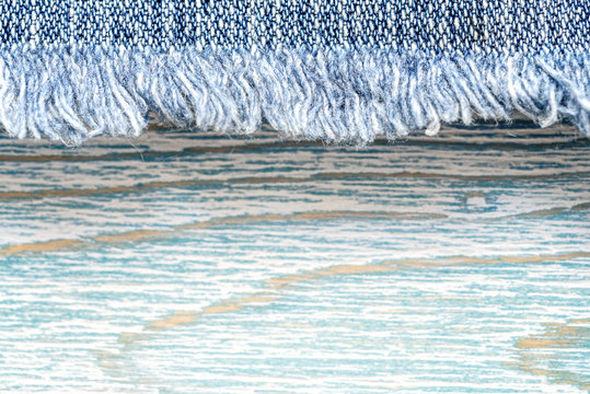 Denim texture on blue wooden background, border