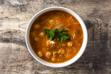 Harira soup in bowl on wooden table. Typical Moroccan food. Ramadán concept.Top view