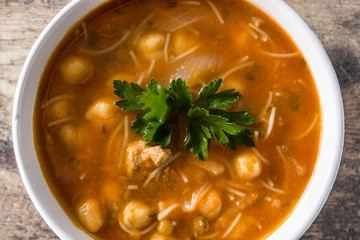 Harira soup in bowl on wooden table. Typical Moroccan food. Ramadán concept.Close up