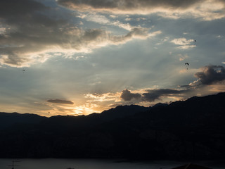 Paragliding during sunset lake Garda Italy