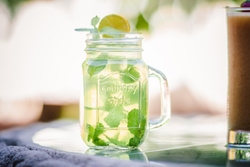 Mojito cocktail served on glass at outdoors, refreshing cuban cocktail