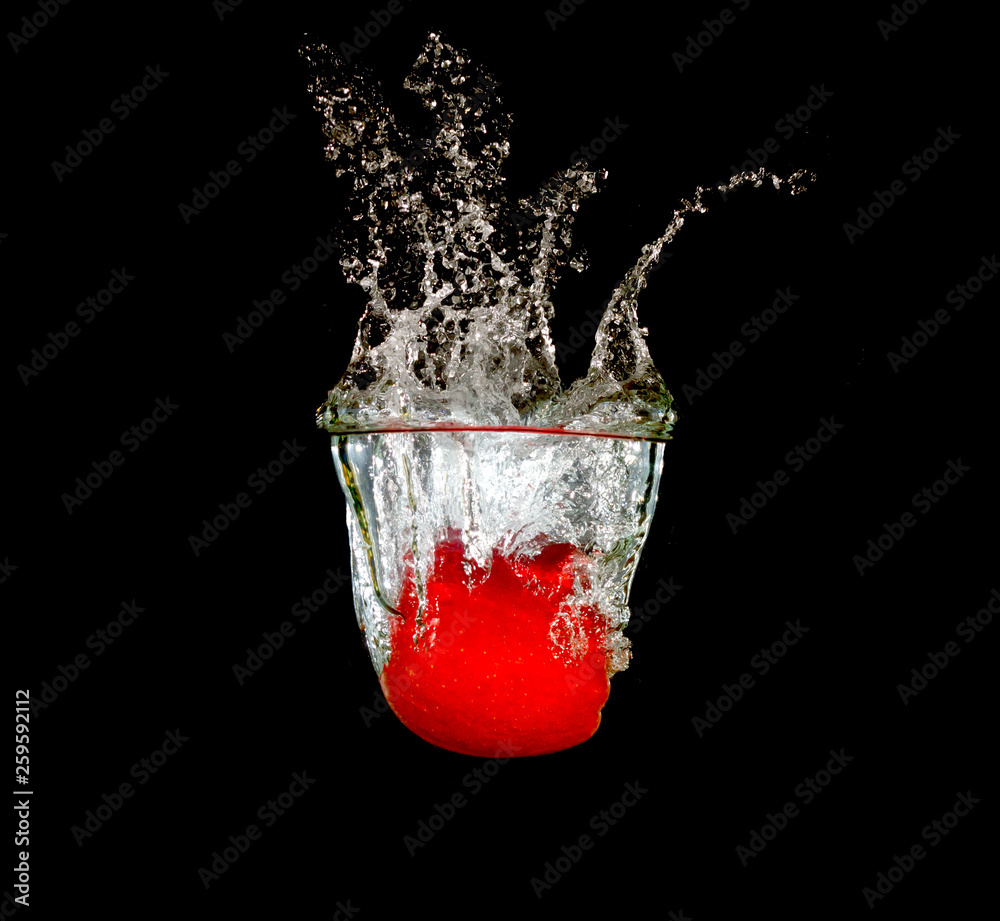 Wall mural fresh red apple in water splash on black background