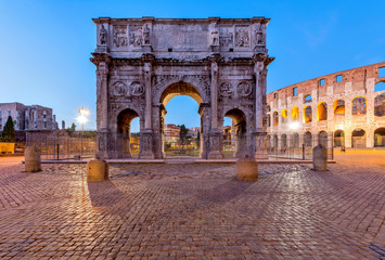 Naklejka premium Arch of Constantine - A dusk view of south side of Constantine's Arch, standing at between the Colosseum, right, and the Roman Forum, left. Rome, Italy.
