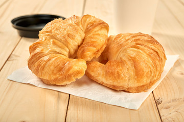 fresh baked croissants on wooden table