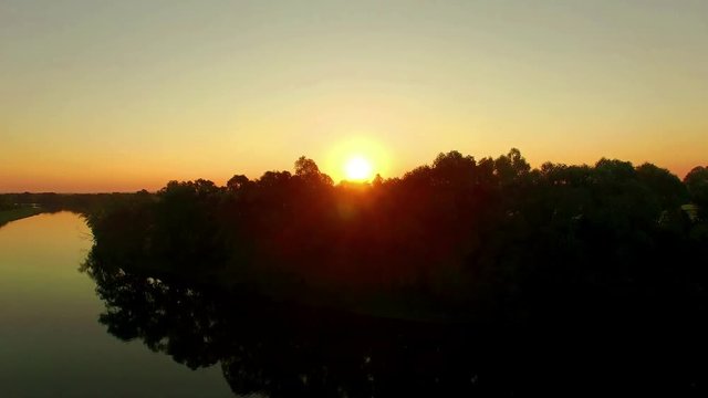 aerial view of river at sunrise 4K, fly over morning mist on the river, Very high view of the river at sunrise, Aerial view of mystical river at sunrise with fog, sun above the river aerial