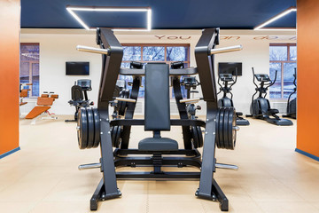 Empty chest press exercise machine in modern gym