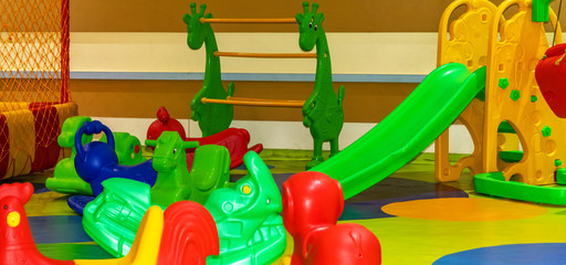 Fototapeta na wymiar Kids play room with lots of toys Game room. Kindergarten, interior of premises.