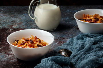 Bowl with cornflakes on a dark gray background