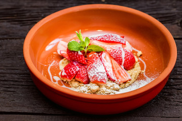 Close up strawberry dessert with cookie crumbles