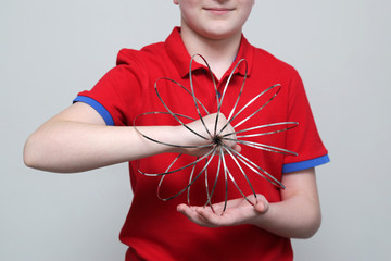 The boy plays with educational kinetic toy for children and teenagers. The development of...