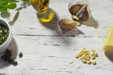 Pesto sauce cooking. Basil, olive oil, parmesan, garlic, pine nuts. Top view on white wooden table