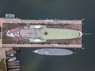Aerial view of passenger ship in shipyard on land for maintenance.