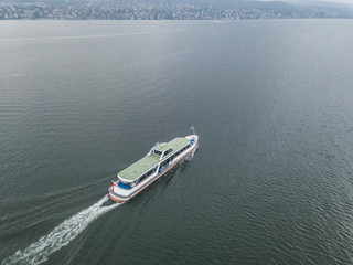 Obraz premium Aerial view of passenger ferry ship cruising on a lake in Switzerland.