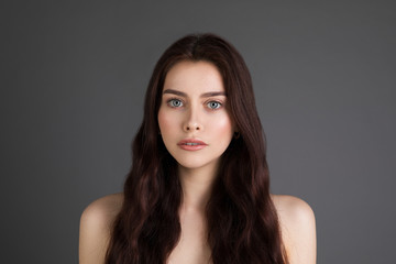 Close up portrait of wonderful young woman with long bronette hair and big blue eyes