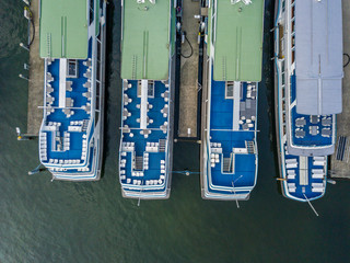 Aerial view of passenger ferry ship in port. Vessels on landing stage for maintenance