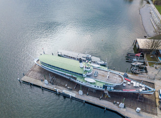 Aerial view of passenger ship in shipyard on land for maintenance.