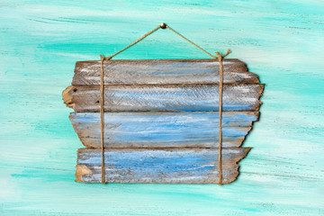 Vintage blue wooden signboard for information hanging by rope