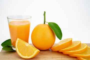Orange juice and oranges with leaves