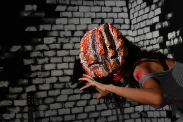 Obraz premium A girl wear halloween mask and haunt acting