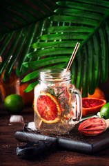 Summer cold soft drink with red orange, soda, citrus fruit juice and chia seeds. Healthy fitness drink. Ingredients for cooking on wooden table background, selective focus