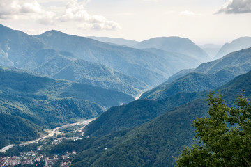 Fototapeta na wymiar The gorge among the mountains with green slopes.